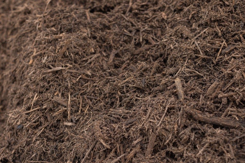 Pile of dark brown mulch.