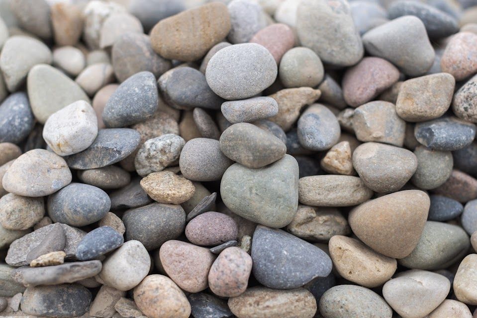 Pile of smooth, multicolored river rocks.