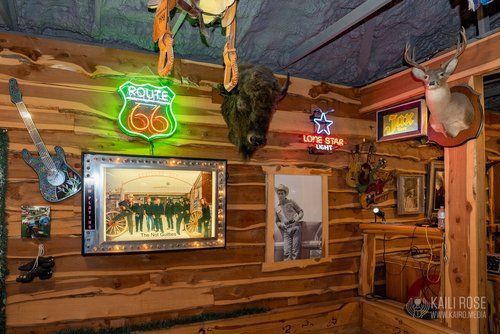 There is a neon sign on the wall that says route 66.