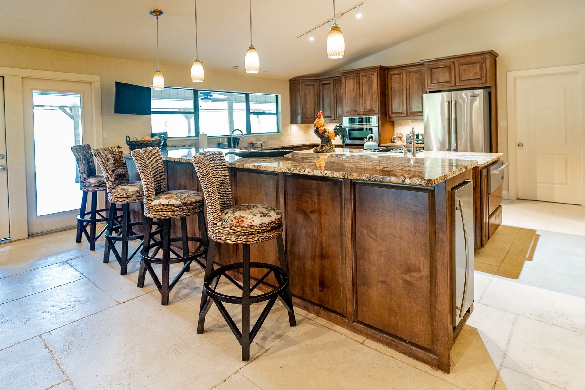 A kitchen with a large island and stools