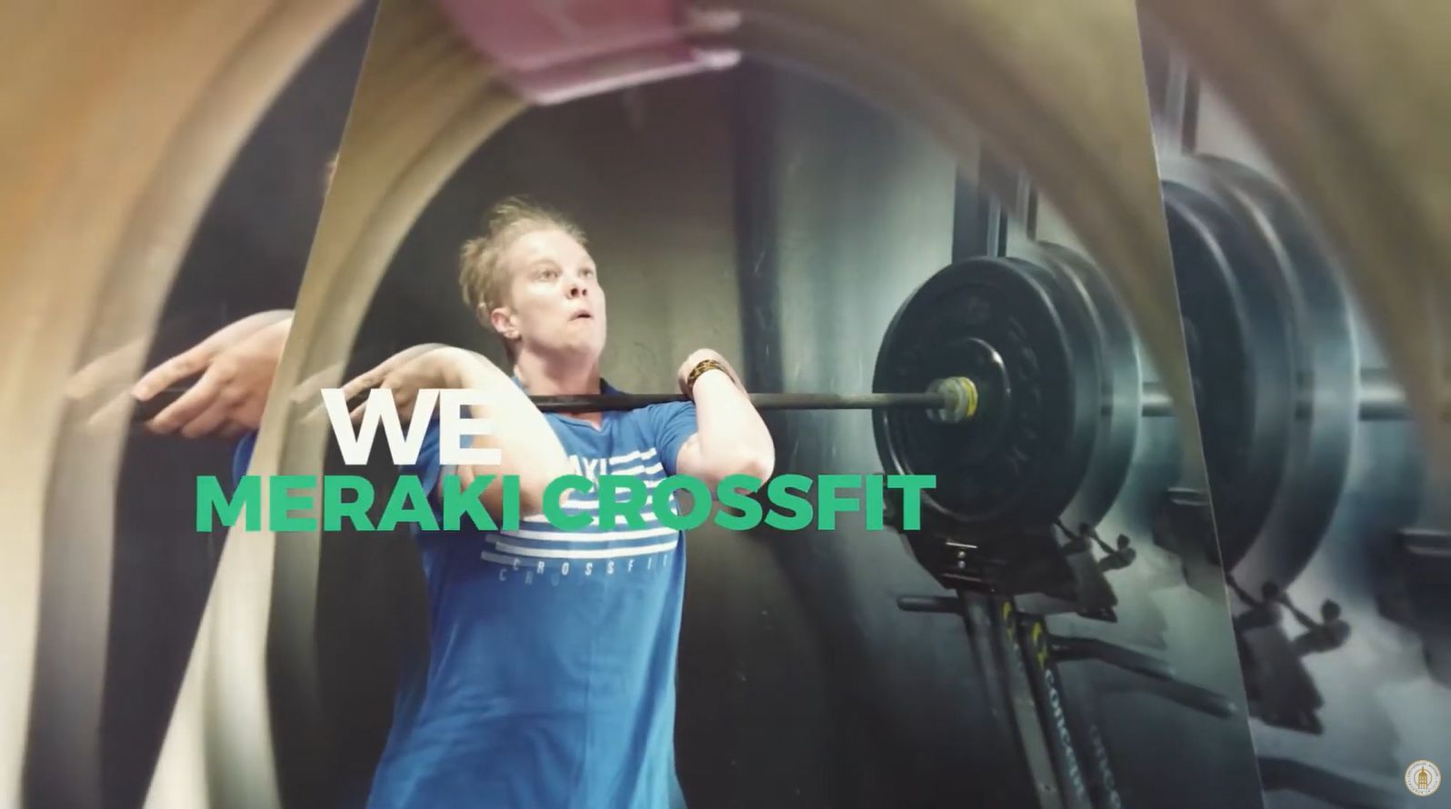 Woman lifting a barbell in a CrossFit gym, with 
