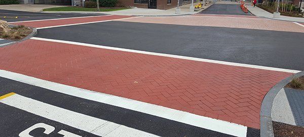 A brick walkway is painted on the side of the road.