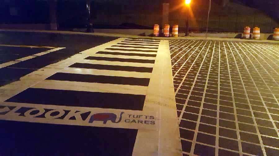 A black and white crosswalk with a sign that says ' the ta 's cares ' on it