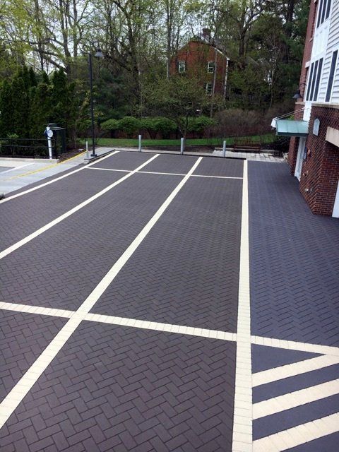 A parking lot with a house in the background