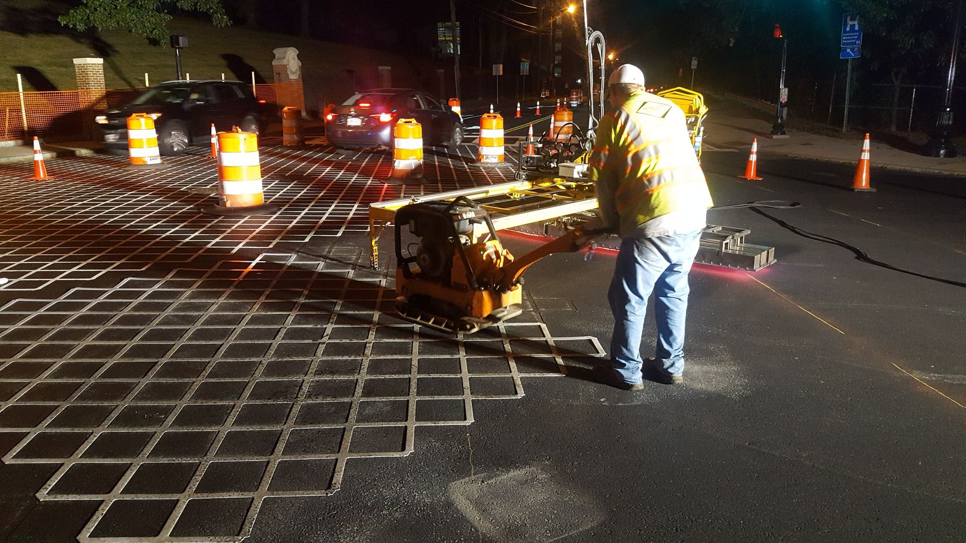 A man is working on a road at night