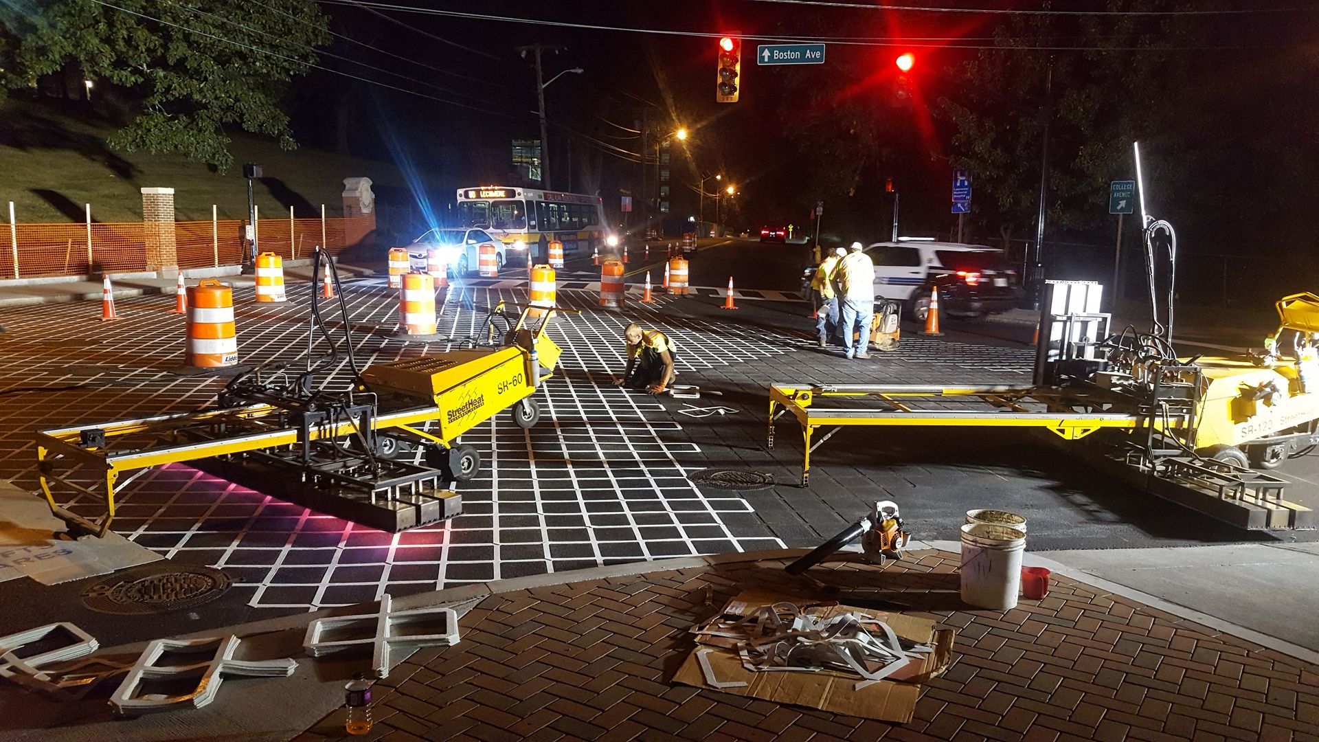 A construction site at night with a red light in the background