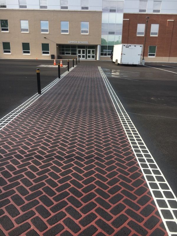 A brick walkway leading to a building that says ' american legion ' on it