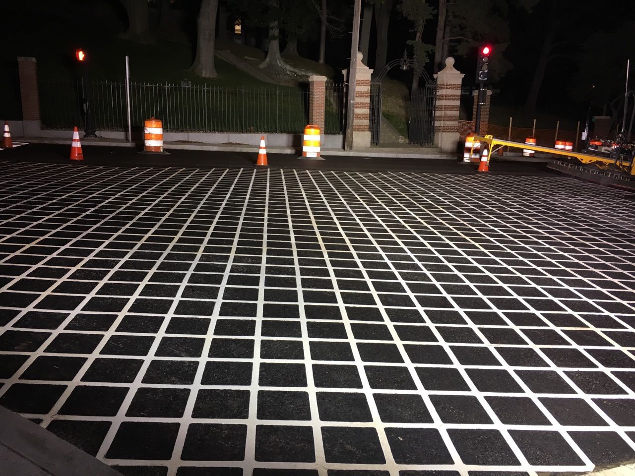 A black and white checkered floor with a red light in the background