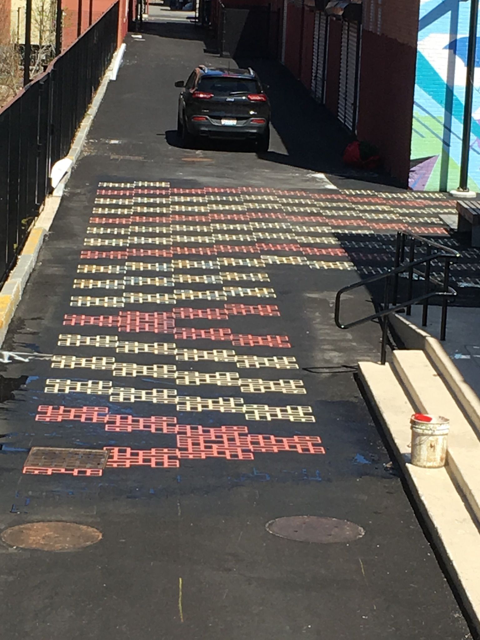 A car is driving down a street with graffiti on it