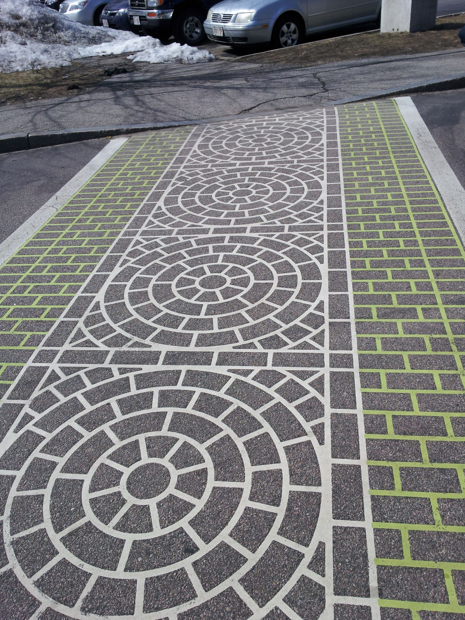 A sidewalk with a circular pattern painted on it