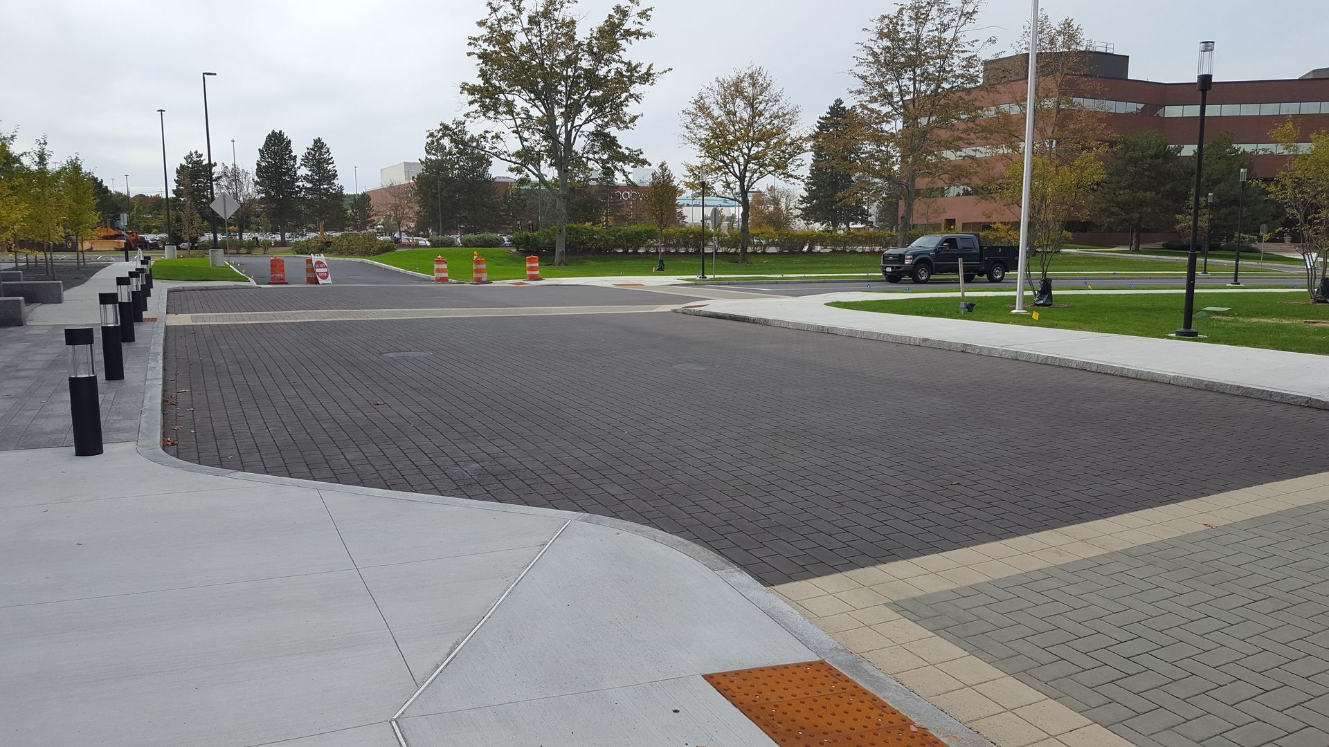 A black truck is parked on the side of the road