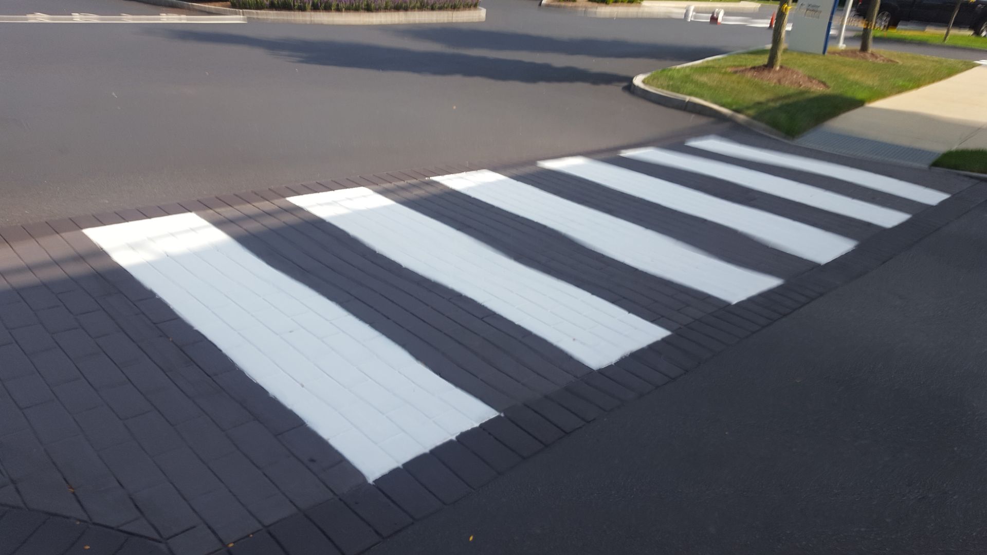 A black and white crosswalk painted on the side of the road