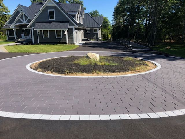 A house with a circular driveway in front of it