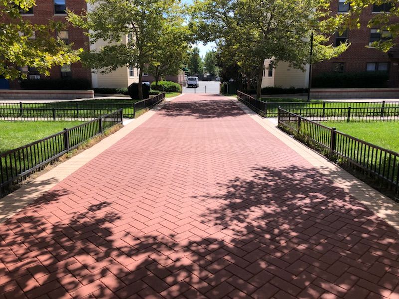A red brick walkway leading to a building
