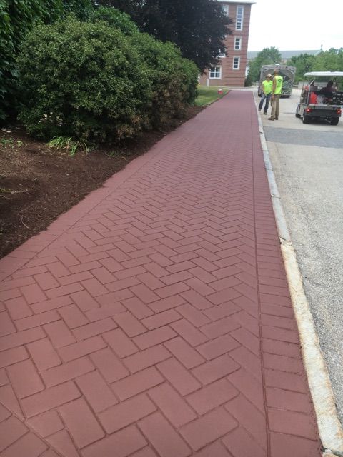 A red brick walkway with a herringbone pattern