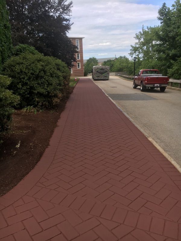 A red truck is parked on the side of the road