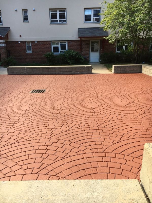 A red brick driveway in front of a building