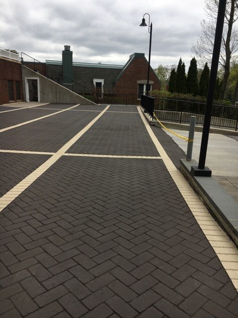 A parking lot with a herringbone pattern and white lines