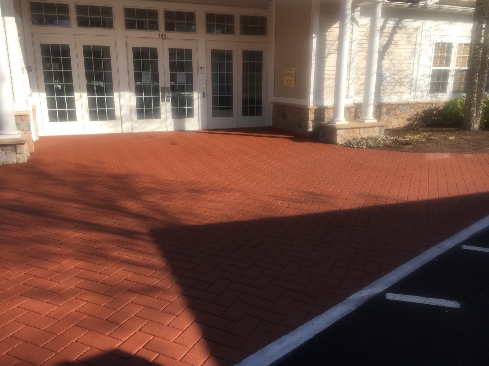 A red brick driveway in front of a building