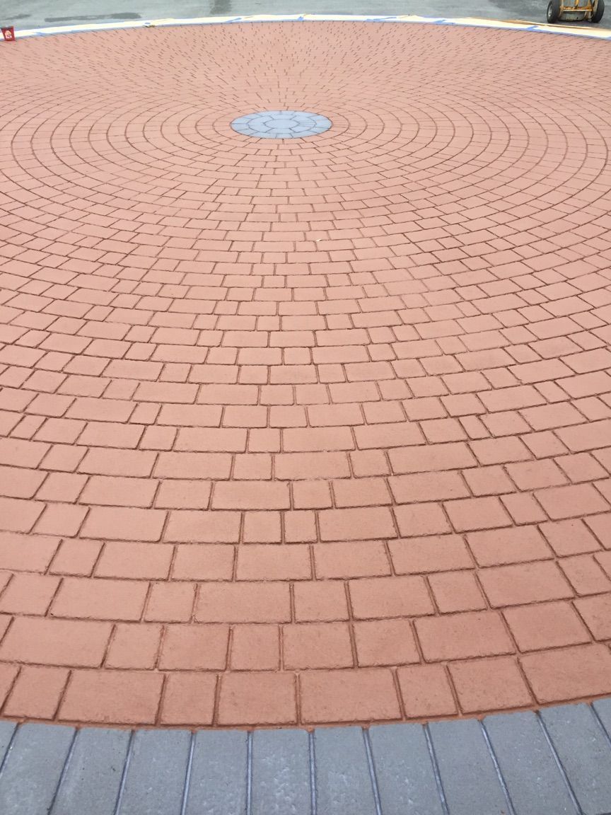 A circular brick walkway with a blue circle in the middle