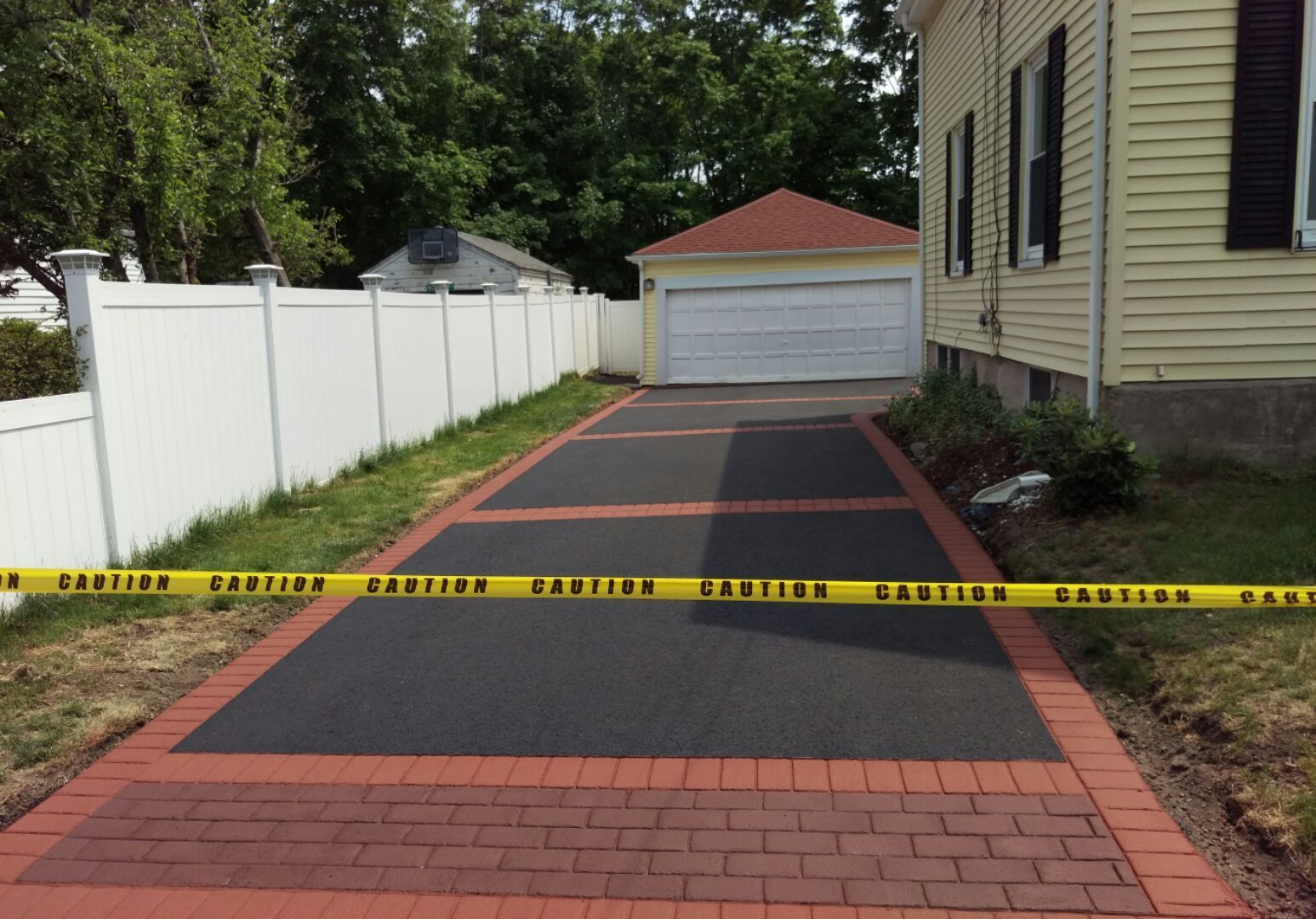 A driveway with a yellow caution tape around it