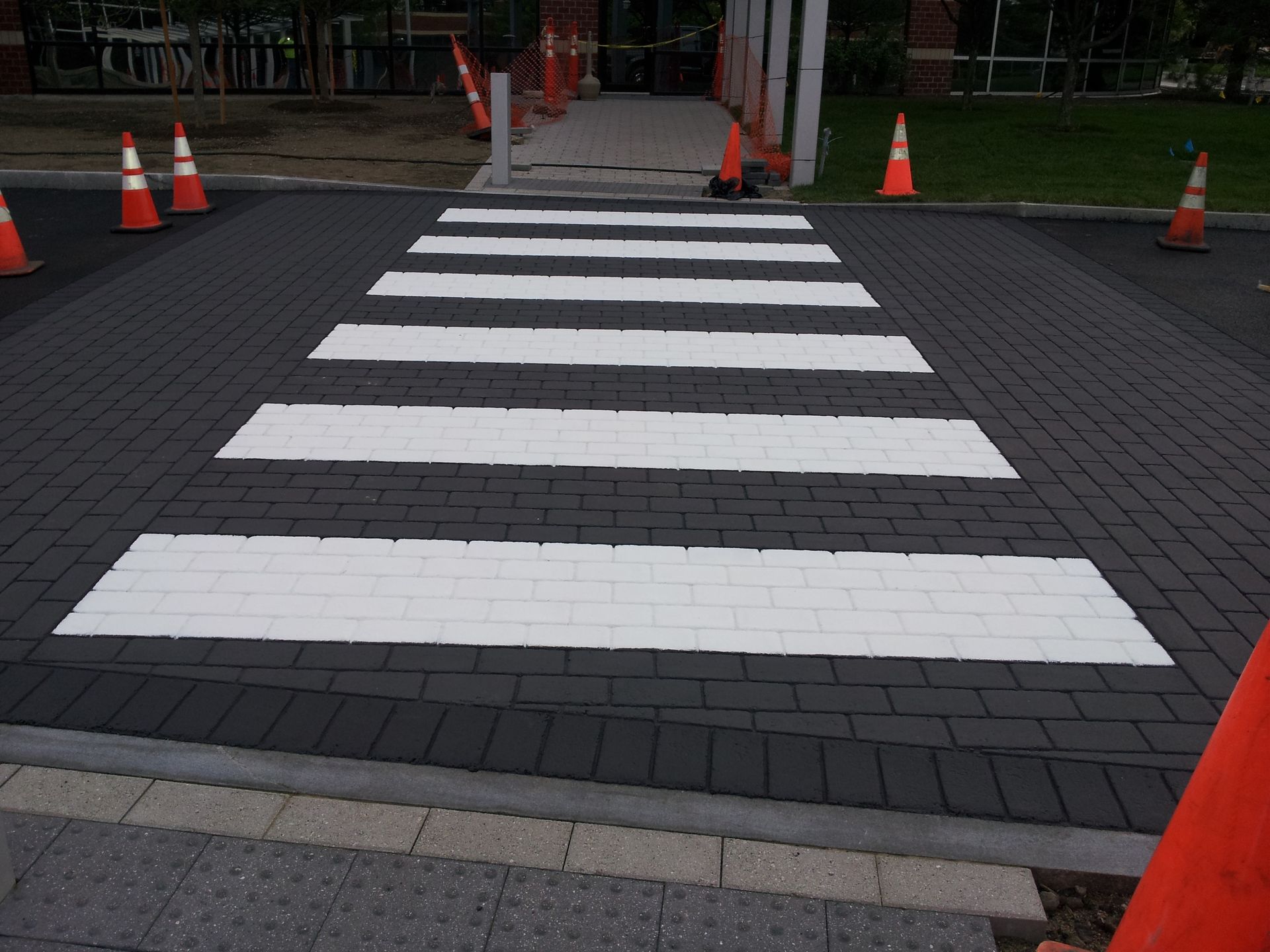 A crosswalk with white stripes painted on it
