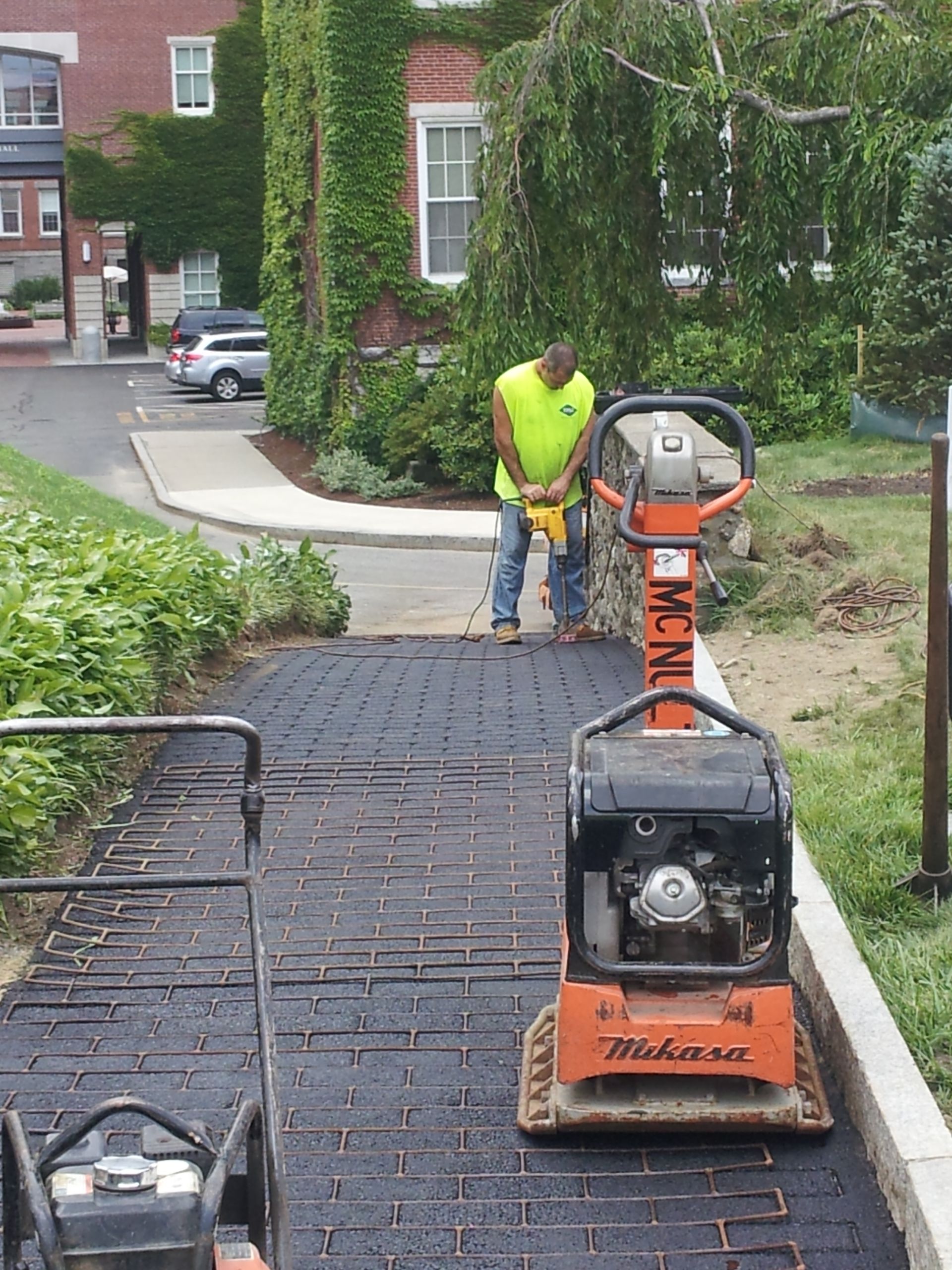 A man standing next to a machine that says mckenzie on it