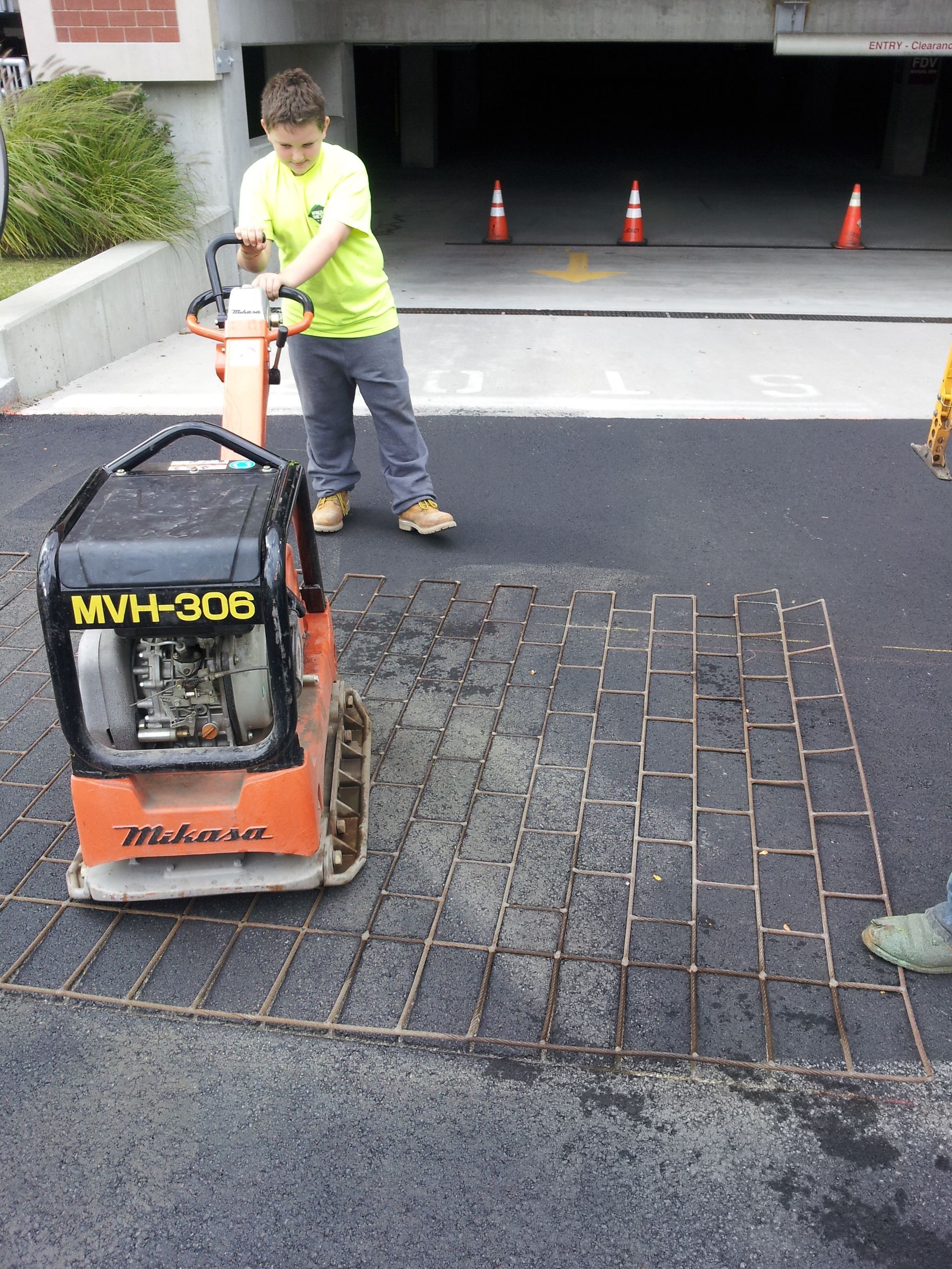 A man is using a machine that says mwh 308