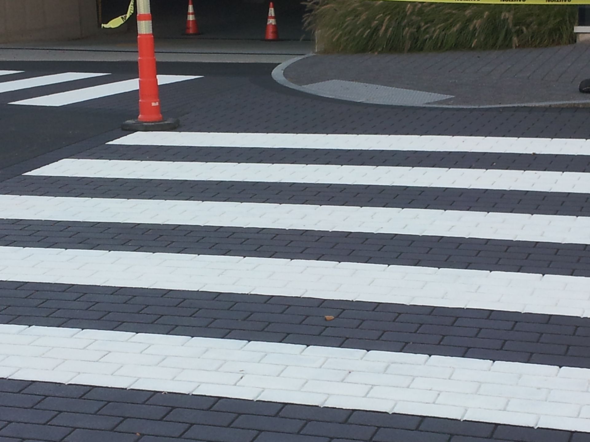 A crosswalk with white stripes painted on it