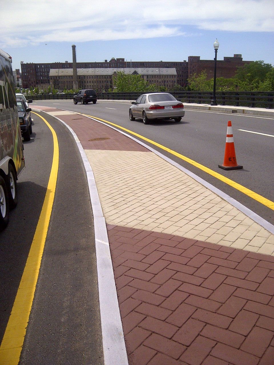 A car is driving down a street with a yellow line
