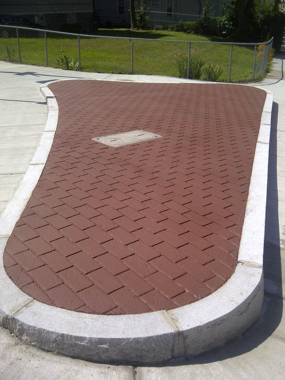 A brick walkway with a white arrow pointing to the right