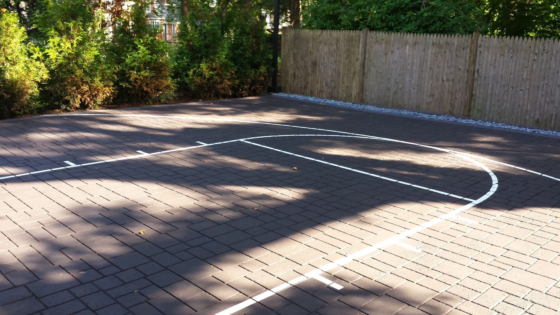 A basketball court with a fence in the background