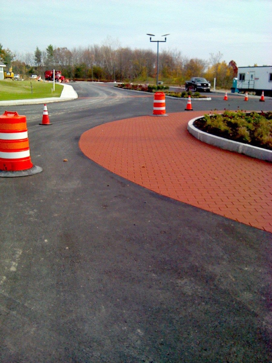 A road with orange and white traffic cones on it