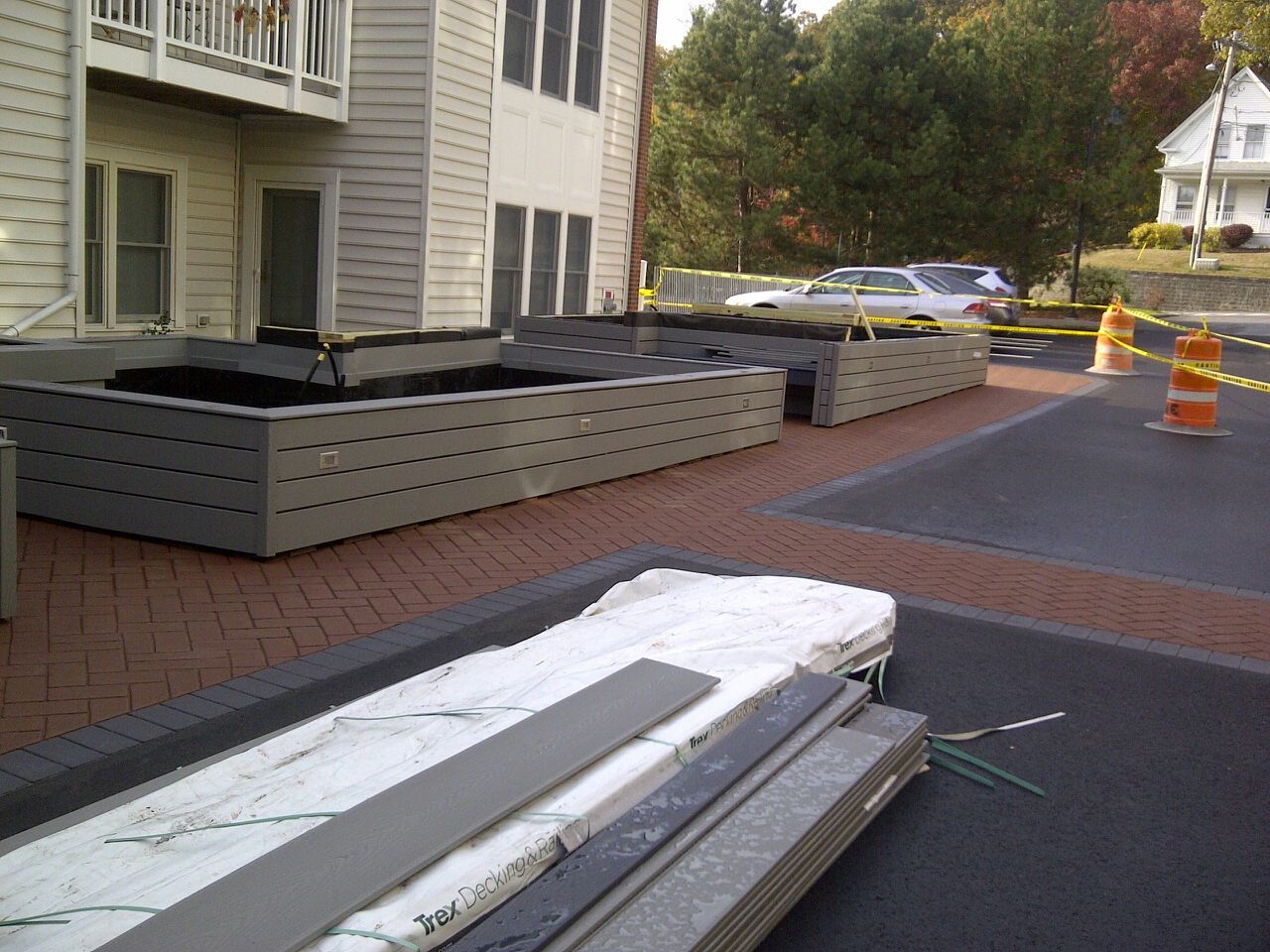 A brick walkway with a building in the background