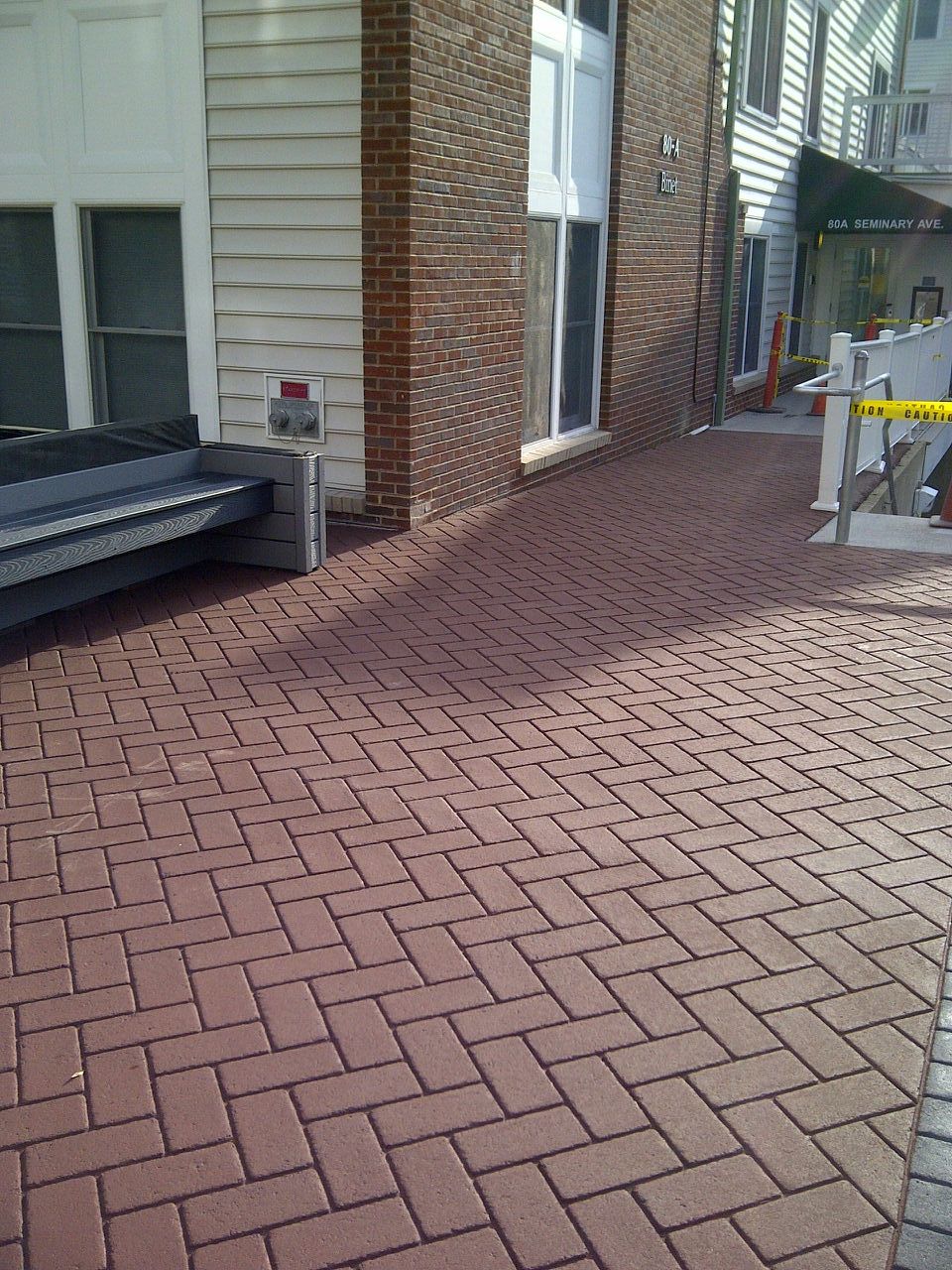 A brick walkway in front of a brick building