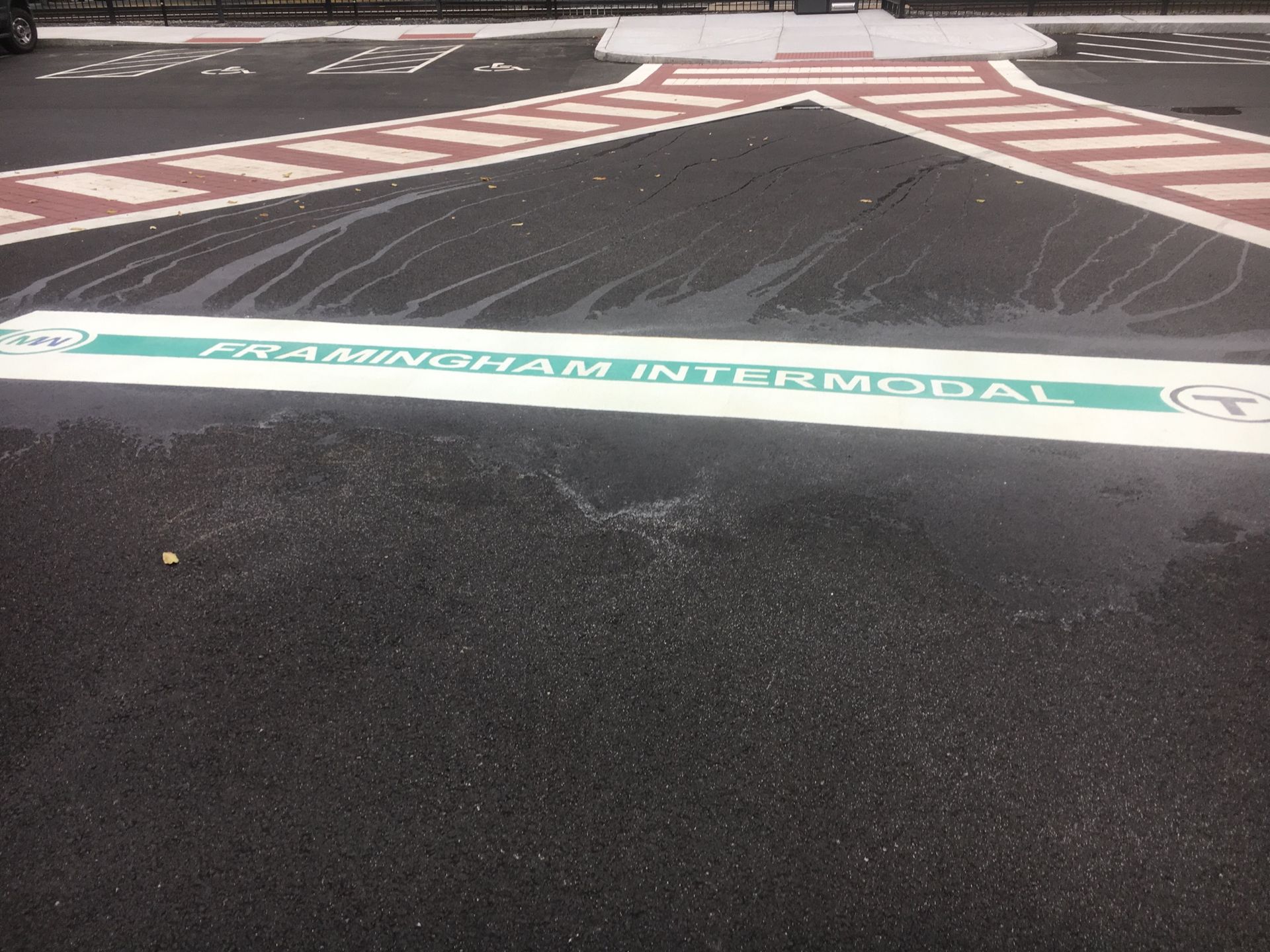 A green and white sign on the road says