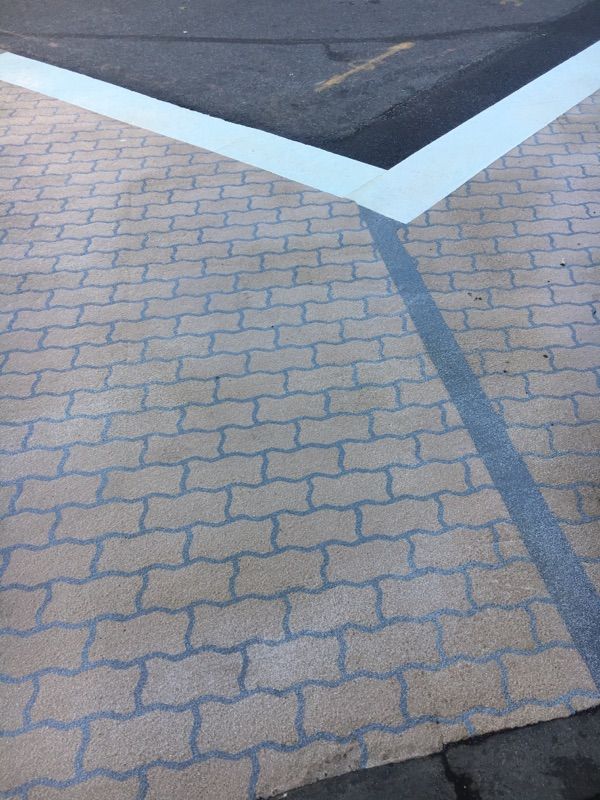 A brick pavement with a white line on it