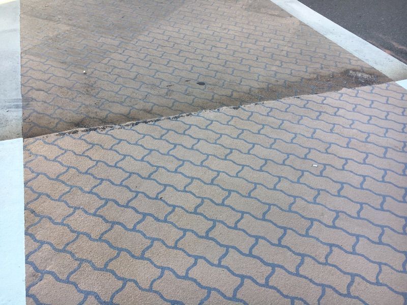 A brick sidewalk with a white line on it