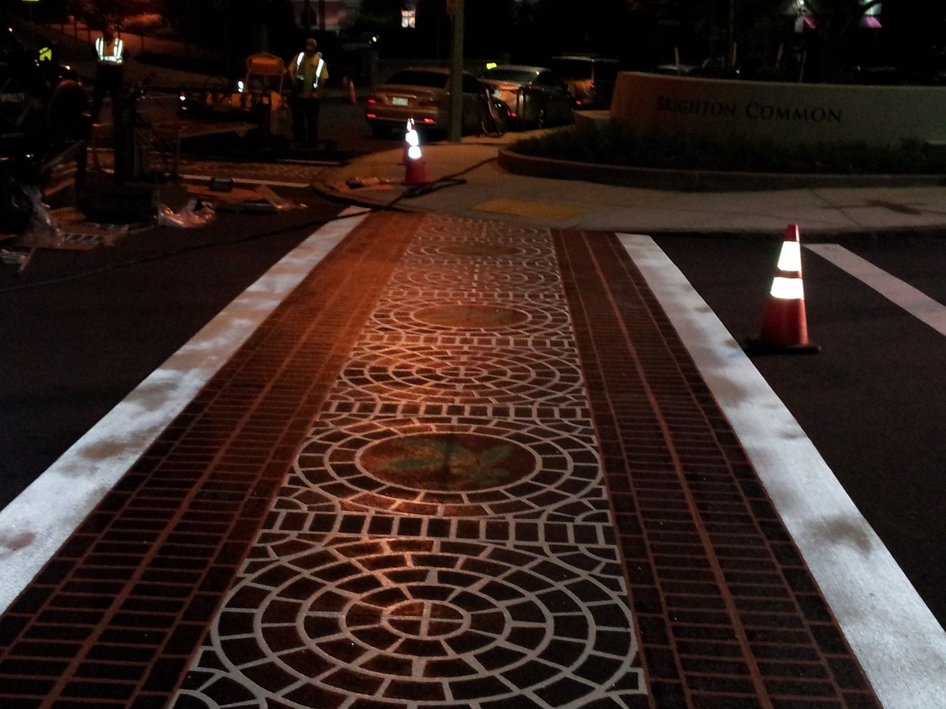 A brick walkway with a circular pattern painted on it