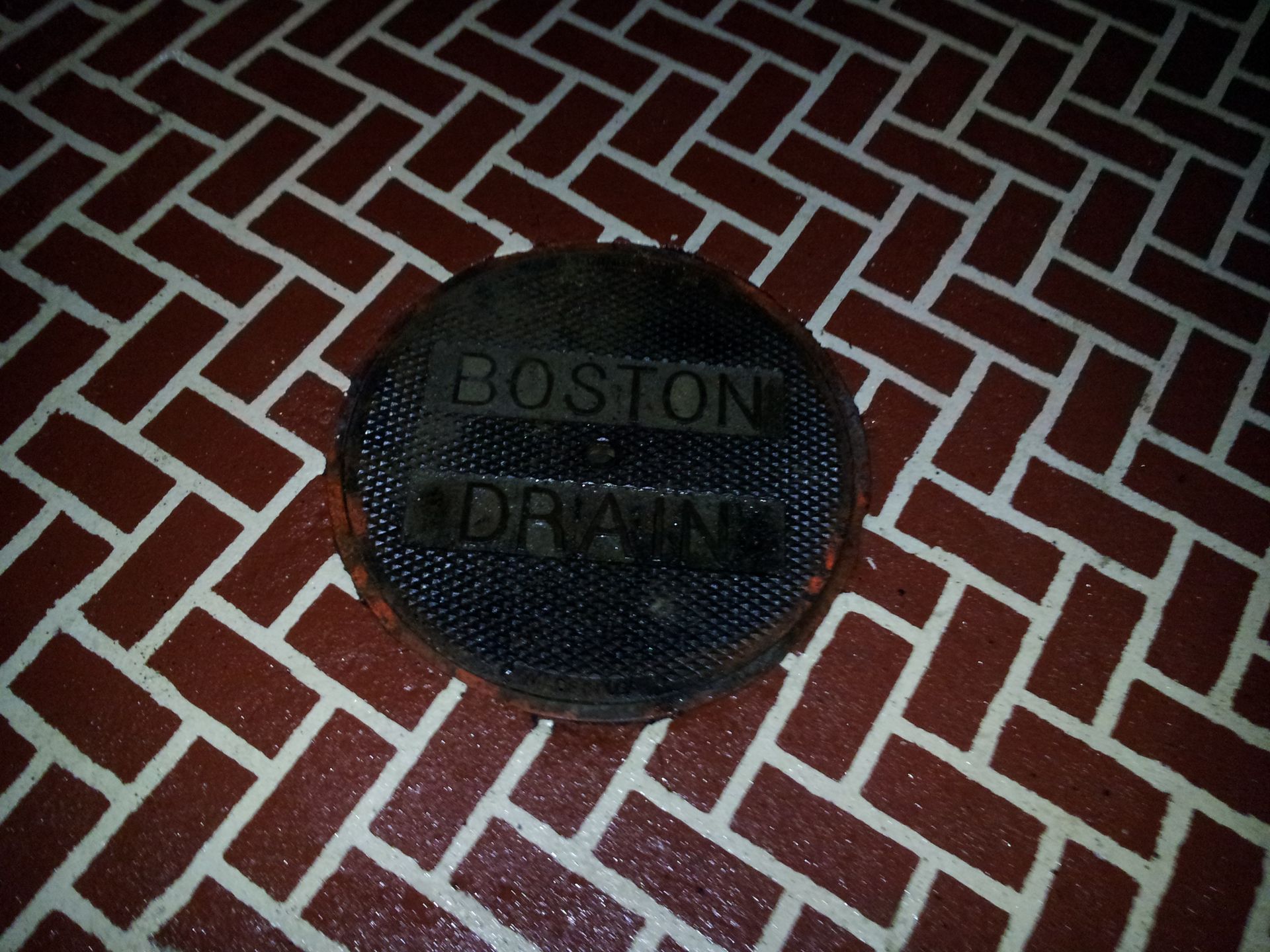 A manhole cover with the word boston on it