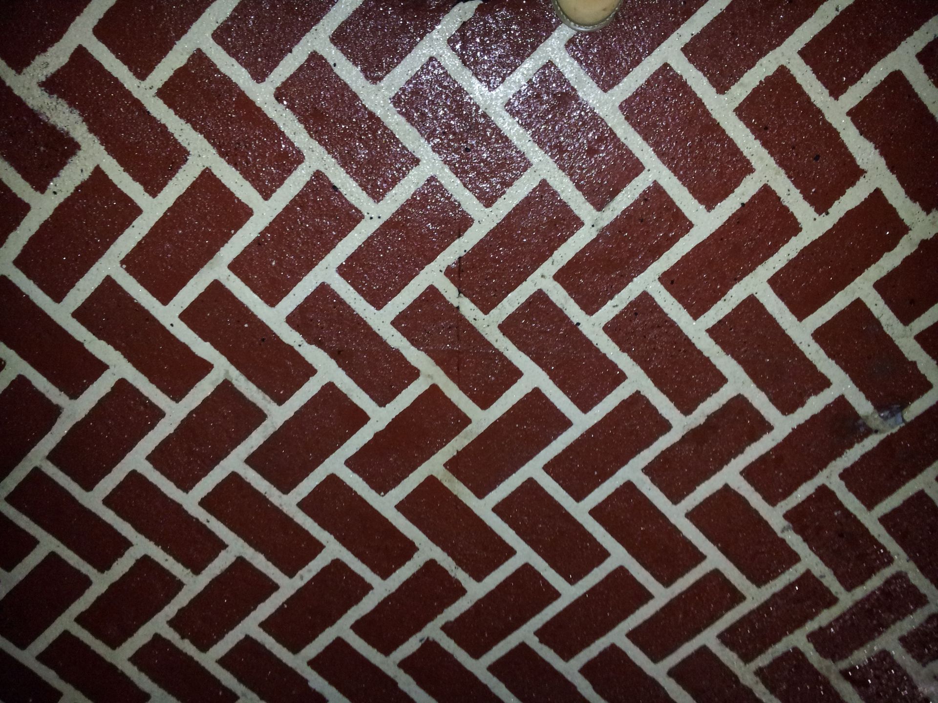 A brick wall with a herringbone pattern painted on it