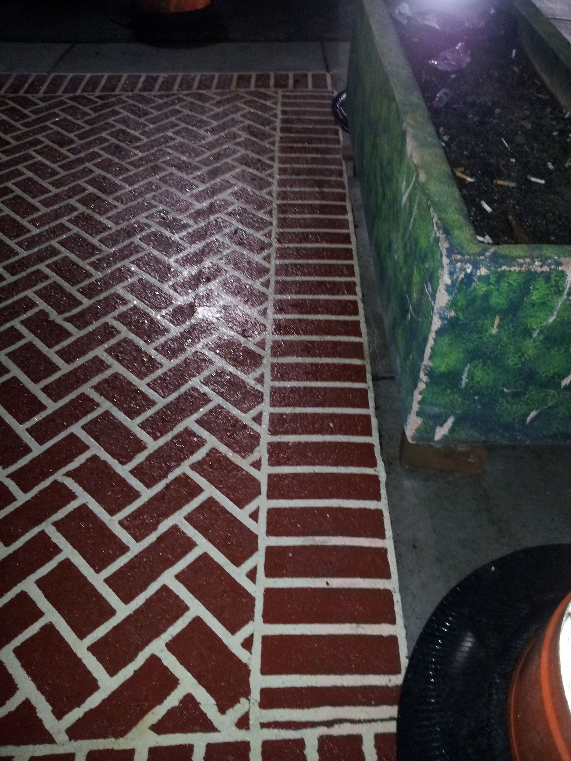 A brick floor with a herringbone pattern on it