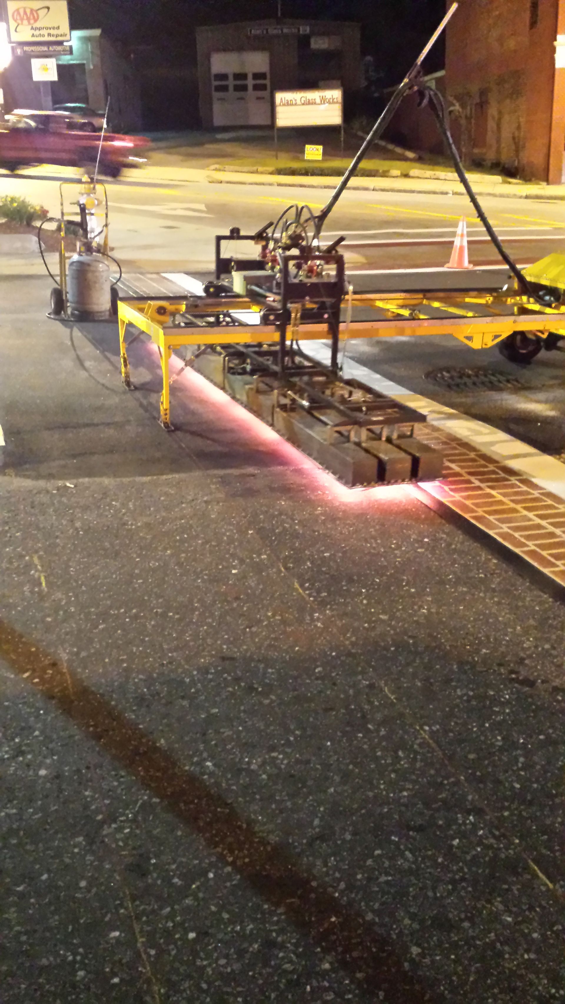 A machine is being used to paint a line on the road
