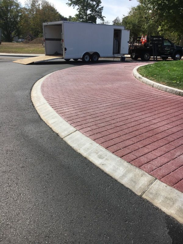 A white trailer is parked on the side of the road