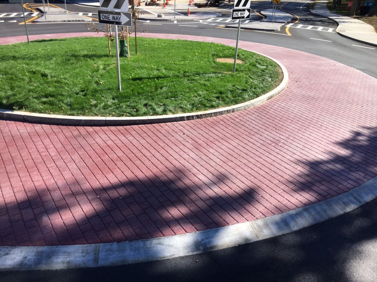 A roundabout with a grassy area in the middle of it