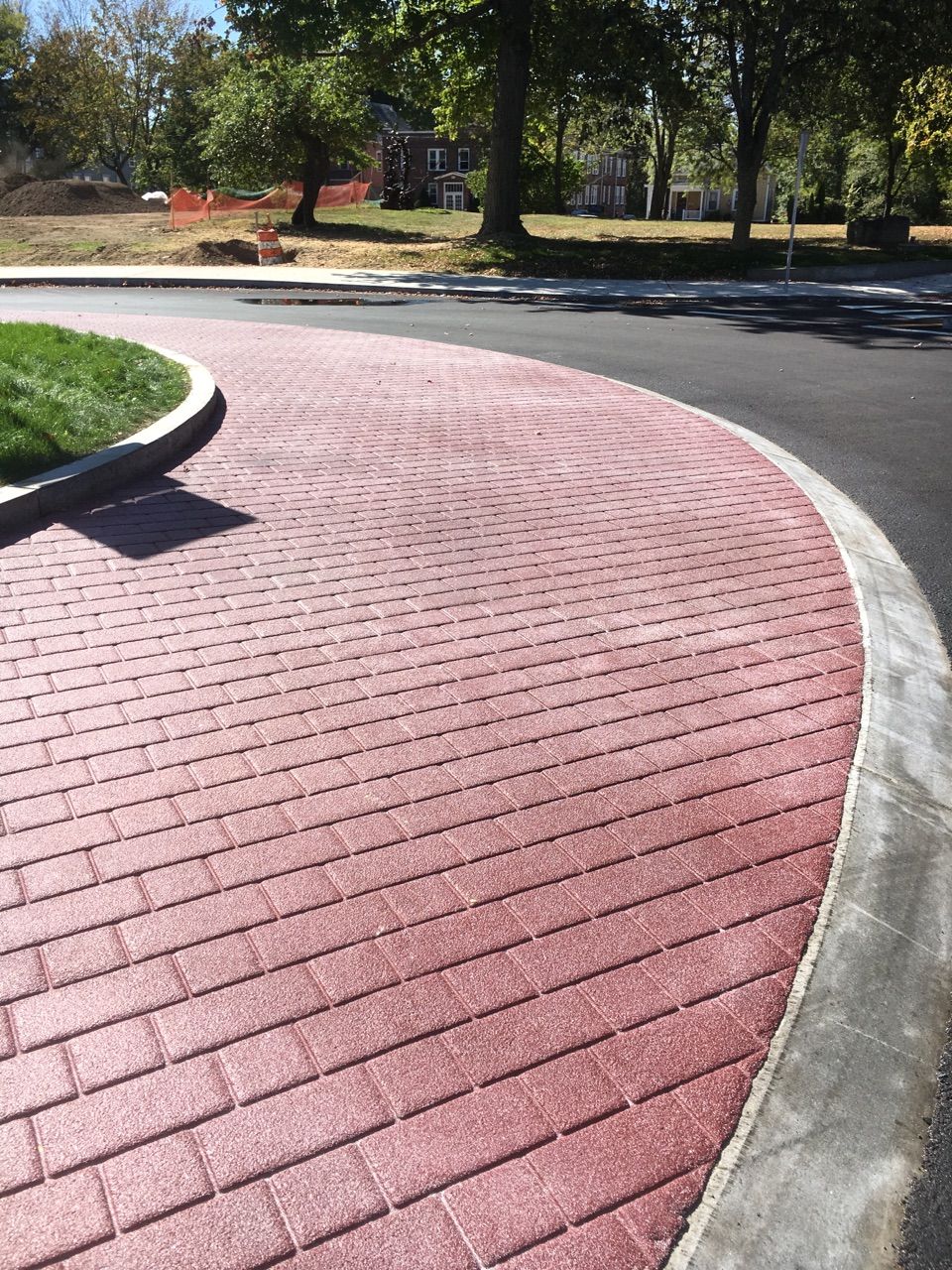 A red brick curb on the side of a road