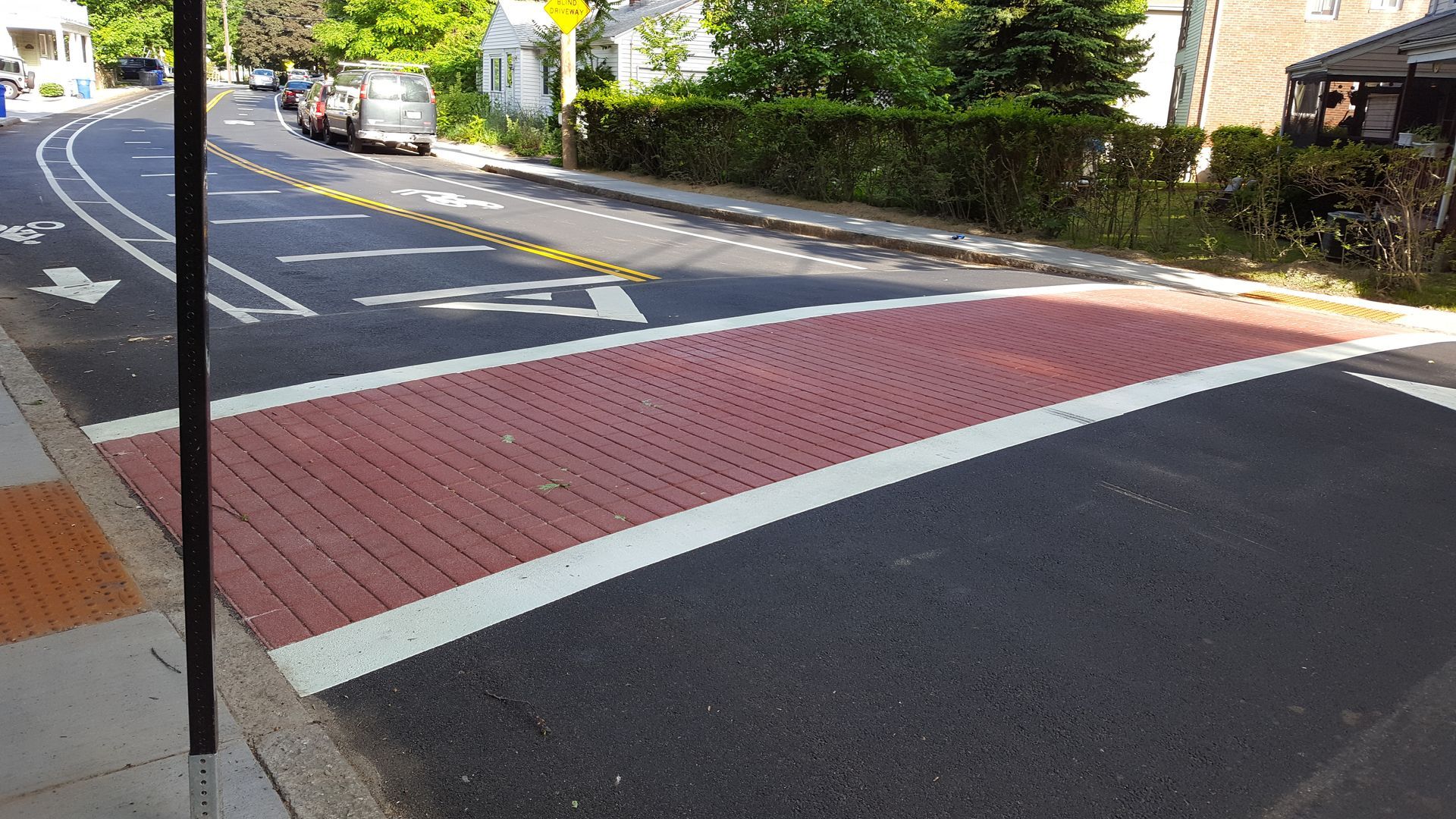A red and white brick crosswalk on a street
