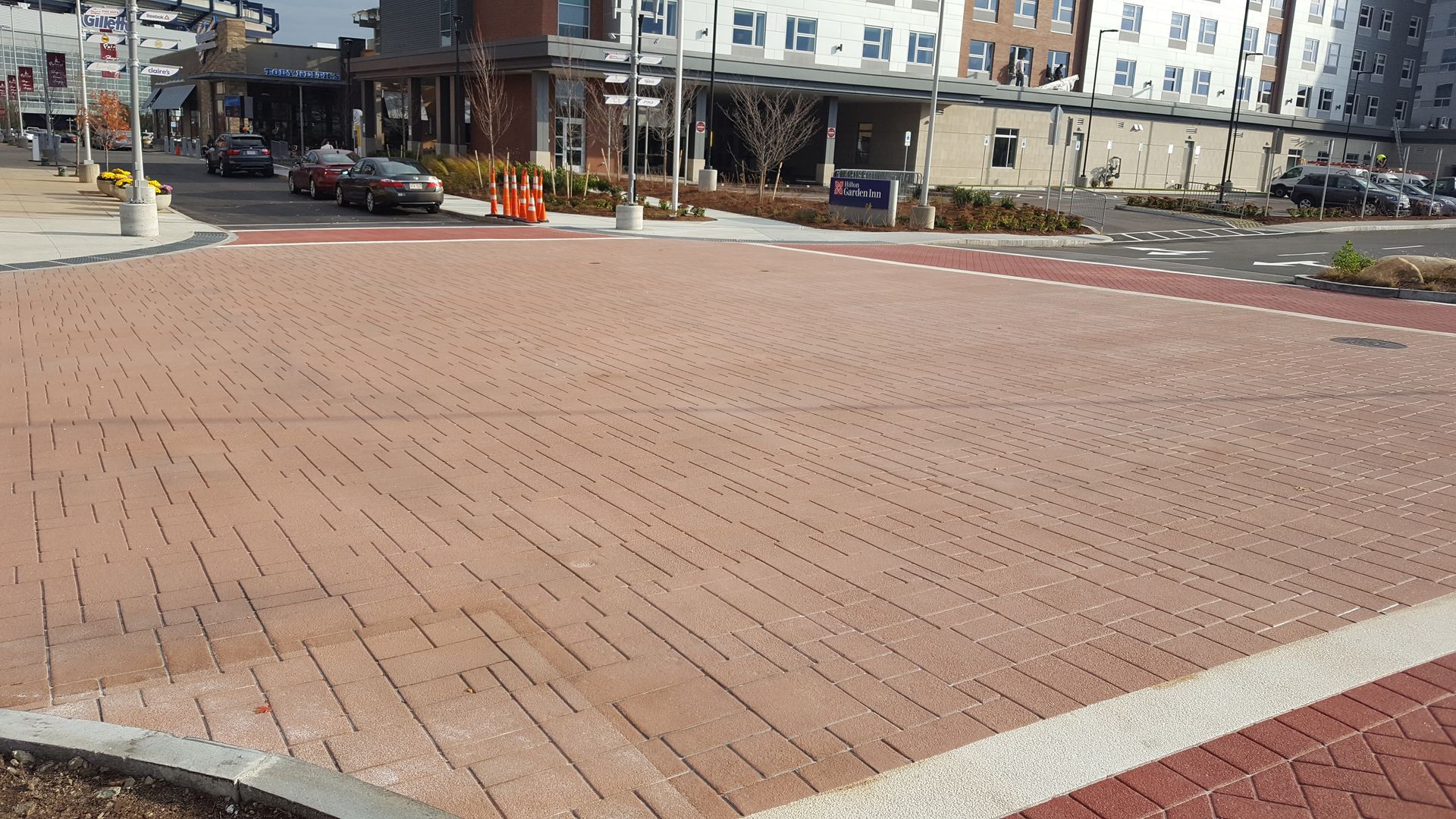 A brick pavement in a city with a building in the background