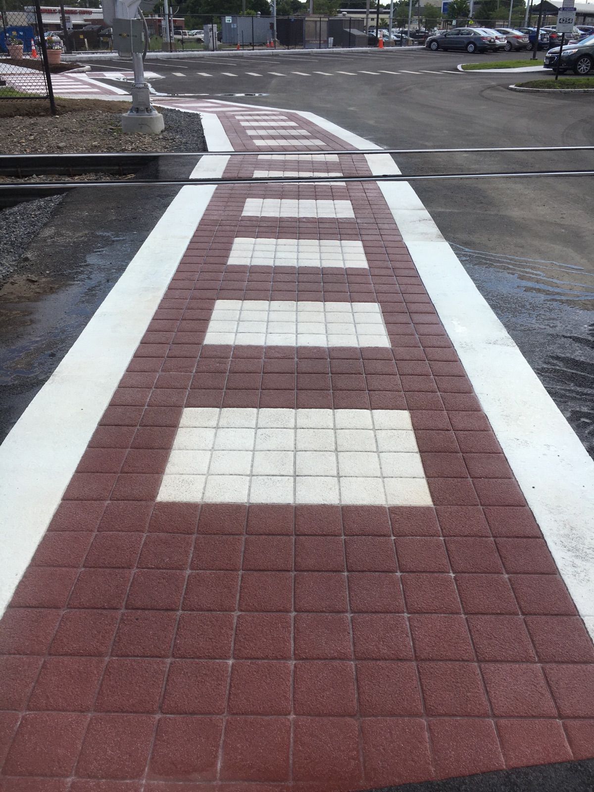 A red and white brick walkway with a white line