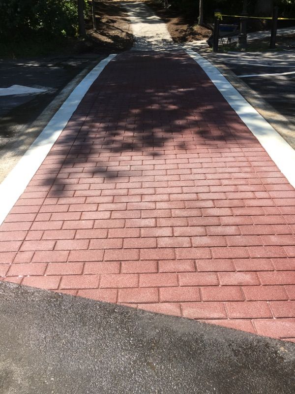 A red brick walkway with a white line on the side